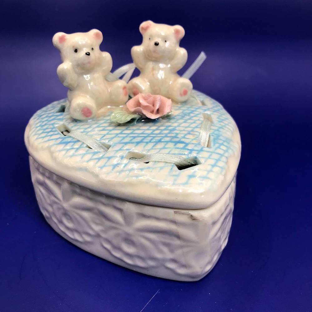 Porcelain Heart Trinket Box  2 Bears + Rose atop a blue quilt with ribbon trim.